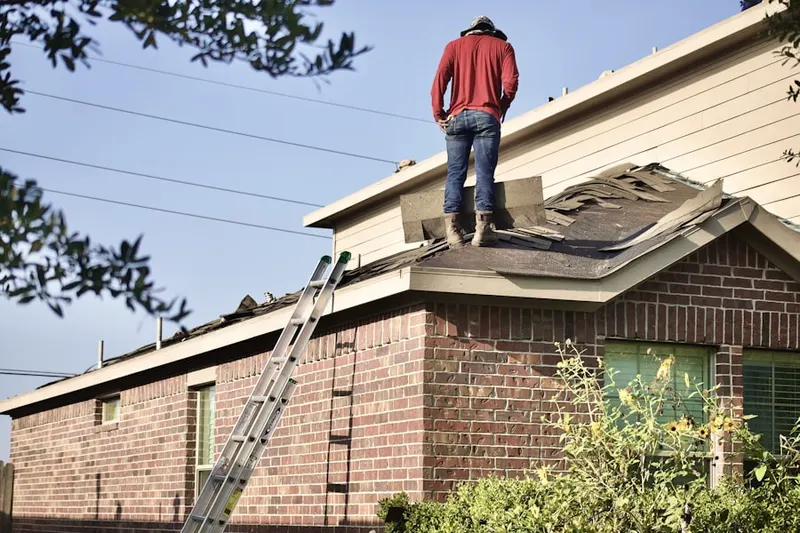 Professional roofer working on a residential roof in Pico-Robertson